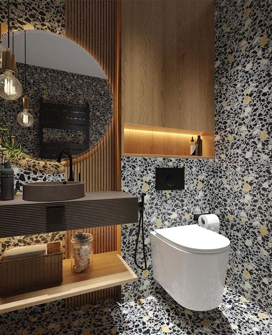 Salle de bain contemporaine habillée de terrazzo graphique noir et beige créant une surface décorative unique