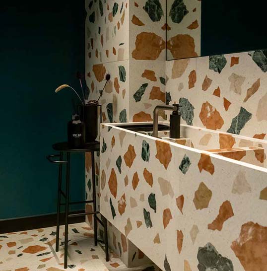 Vasque et revêtement en terrazzo multicolore dans une salle d’eau contemporaine aux lignes épurées